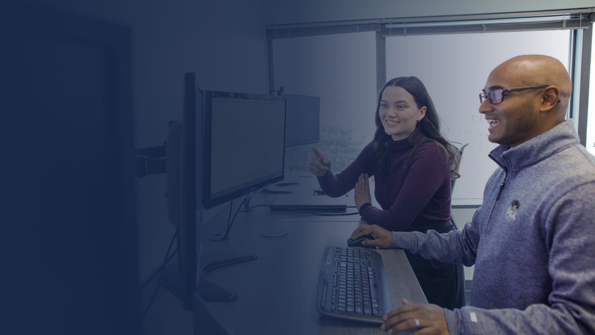 Man and Women looking at computer screen together