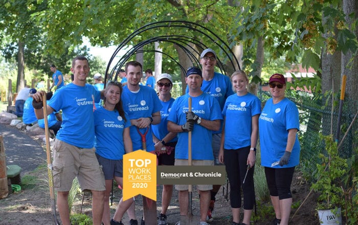 Rochester Top Workplaces 2020 logo over a team photo from Insero's first Volunteer Day