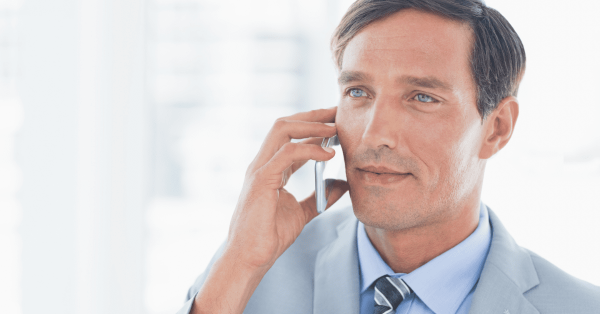 businessman holding a cell phone making customer service mistakes on a call