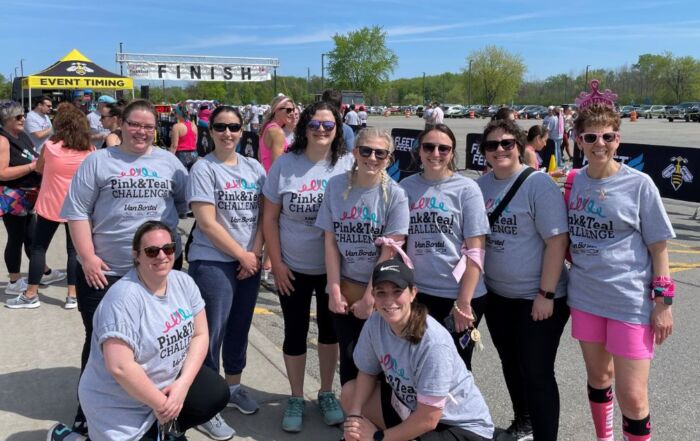 women in grey t-shirts at a charity run/walk for breast cancer while working for one of the best accounting firms to work for