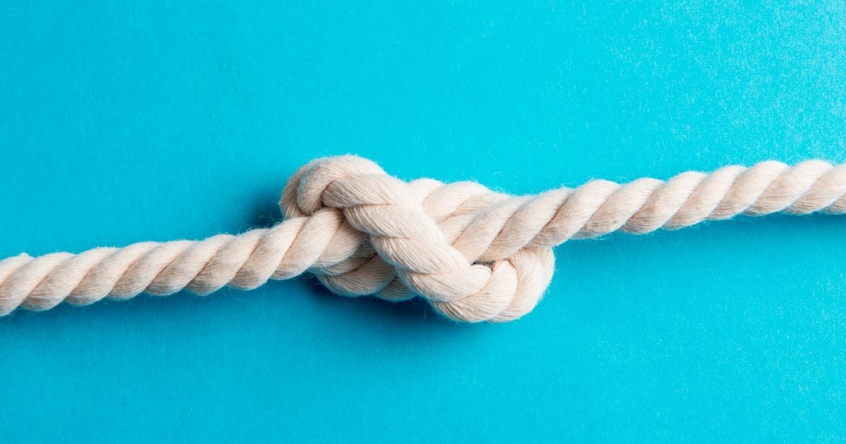 white rope with knot on a blue background symbolizing create a strong bond with customers and employees